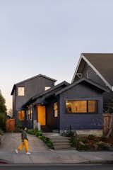 The house, painted in Poppyseed by Behr, now features a second-floor loft for the couple’s sons and a newly vaulted living room at the front. The board-formed concrete foundation was an early change.